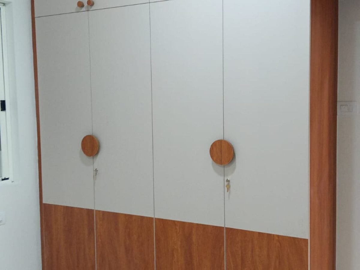 Four door wardrobe in ivory and teak with round wooden handles and key locks