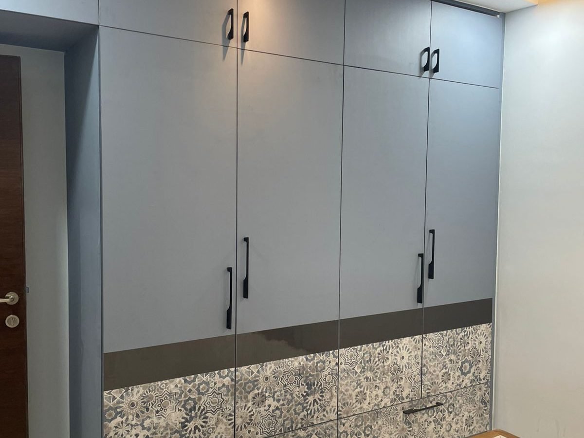 Six door grey wardrobe with patterned base panels and black handles