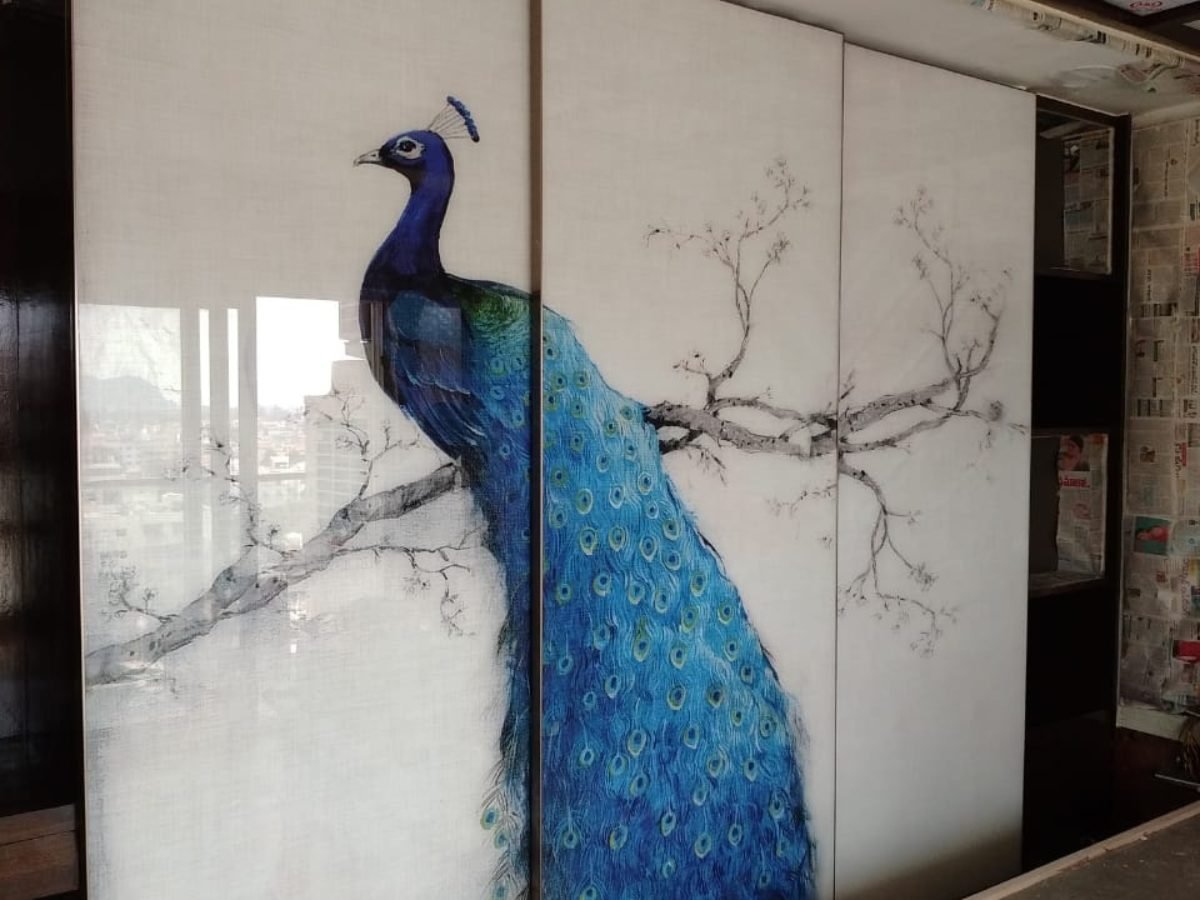 Wardrobe with hand-painted peacock artwork across glass shutters