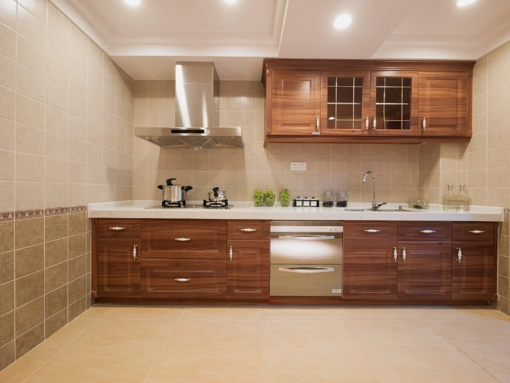 Wooden finish modular kitchen with chimney, tall units and built-in oven